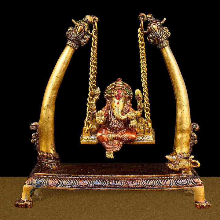 10.2-inch brass Ganpati idol seated on a decorative swing (jhula), beautifully crafted for devotion, home decor, and festive celebrations. India’s Largest Brass Idols Brand - www.satvikworld.com