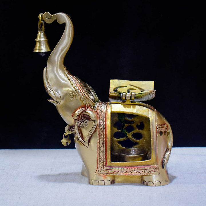 10.6 Inch Brass Elephant Tealight Holder featuring an elegant design with an attached bell, perfect for enhancing home ambiance and pooja décor settings with a touch of traditional charm. India’s Largest Pooja Accessories Brand – www.satvikworld.com