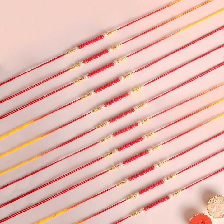 Assortment of 12 Rakhis, featuring different designs, threads, and embellishments for Raksha Bandhan. India’s Largest Pooja Accessories Brand - www.satvikworld.com