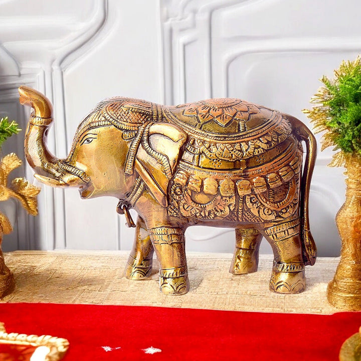 4.7 Inch Brass Elephant Statue with Upward Trunk: A Symbol of Prosperity and Good Luck. This Exquisite Brass Figurine Features an Elephant with Its Trunk Raised, A Traditional Sign of Abundance, Strength, and Positive Energy. Perfect for Enhancing Home Décor, Office Spaces, or Temple Altars, Bringing Blessings of Success and Harmony. India’s Largest Pooja Accessories Brand – www.satvikworld.com