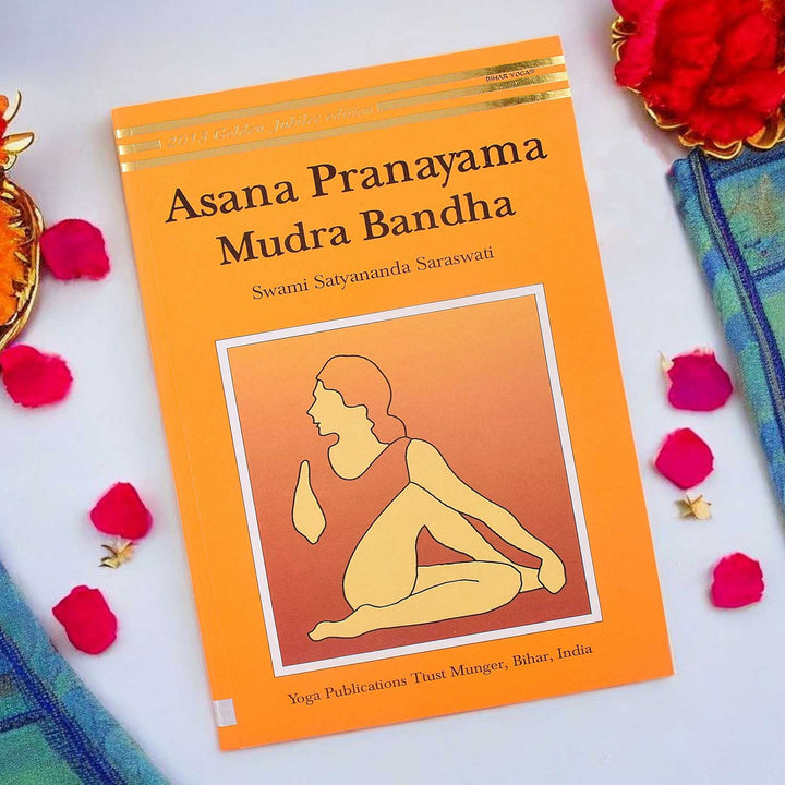 Asana Pranayama Mudra Bandha - Golden Jubilee Edition paperback book showcasing yoga poses, breath control, and ancient practices.India’s Largest Pooja Accessories Brand – www.satvikworld.com