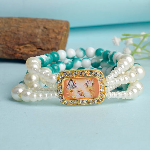 Bluish Green & White Marble Four Layer Guruji Swaroop Bracelet featuring tranquil bluish green beads and marble effect white beads with Jai Guruji Swaroop – perfect for spiritual wear, festive gifting, and daily devotion. India’s Largest Pooja Accessories Brand – www.satvikworld.com