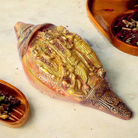 Brass Shankh with Divine Carvings of Ram, Sita, Laxman, and Hanuman, A Beautifully Crafted Conch Shell Featuring Sacred and Intricate Carvings of the Holy Family. This Symbolic Piece Brings Spiritual Blessings and Purity to Your Pooja or Home Temple. The Divine Figures of Ram, Sita, Laxman, and Hanuman Add to Its Spiritual Significance, Making It a Must-Have for Worship and Devotional Decor. India’s Largest Pooja Accessories Brand – www.satvikworld.com