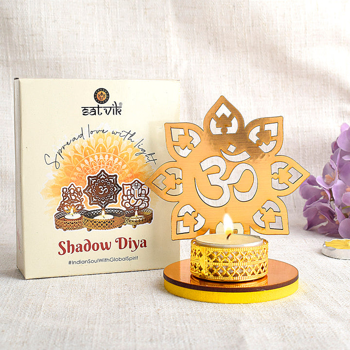Designer OM Shadow Diya made of metal, casting a radiant Om symbol shadow when lit, ideal for spiritual ambiance and festive home decoration. India’s Largest Pooja Accessories Brand – www.satvikworld.com