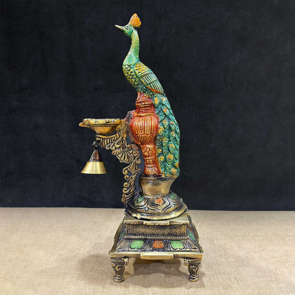 Elegant 14.75-inch Brass Peacock Diya Stand, featuring a beautifully designed peacock motif with intricate detailing, perfect for enhancing the beauty of your pooja altar or home decor. India’s Largest Pooja Accessories Brand – www.satvikworld.com
