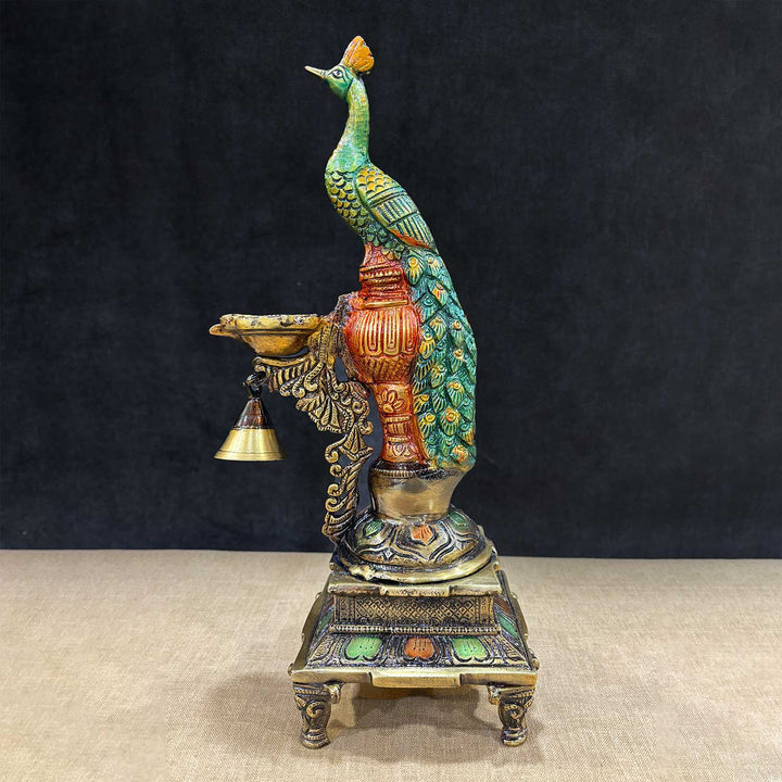 Elegant 14.75-inch Brass Peacock Diya Stand, featuring a beautifully designed peacock motif with intricate detailing, perfect for enhancing the beauty of your pooja altar or home decor. India’s Largest Pooja Accessories Brand – www.satvikworld.com