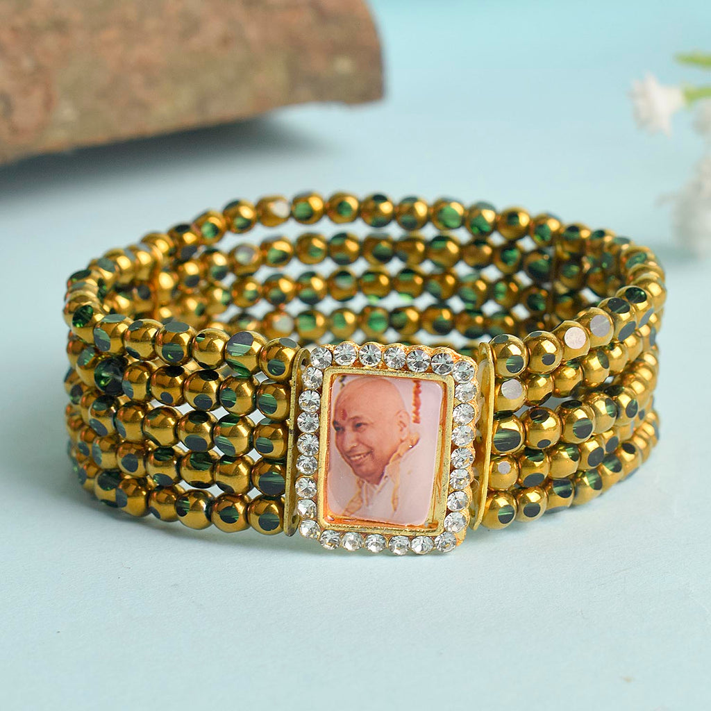 Five Layered Green & Golden Beads Guruji Swaroop Bracelet featuring vibrant layered beads and Jai Guruji Swaroop – perfect for spiritual wear, festive gifting, and daily devotion. India’s Largest Pooja Accessories Brand – www.satvikworld.com
