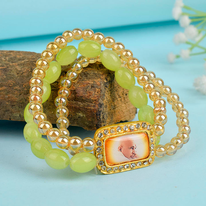 Golden Clear & Green Triple Layer Guruji Swaroop Bracelet featuring sparkling golden clear beads with vibrant green middle layer and Jai Guruji Swaroop – perfect for spiritual wear, meditation, and gifting. India’s Largest Pooja Accessories Brand – www.satvikworld.com