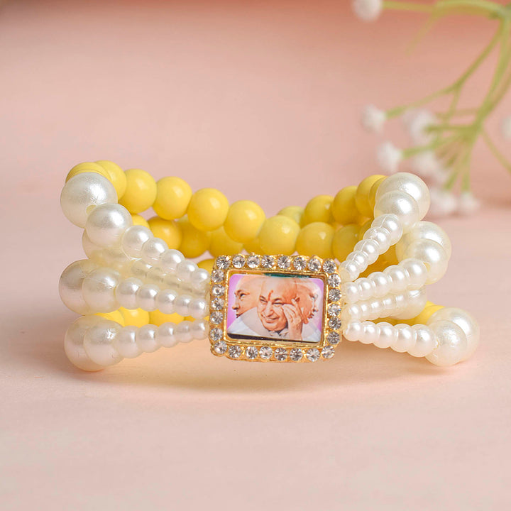Pale Yellow with White Pearl Four Layer Guruji Swaroop Bracelet featuring soft pale yellow beads and radiant white pearls with Jai Guruji Swaroop – perfect for spiritual wear, festive gifting, and daily devotion. India’s Largest Pooja Accessories Brand – www.satvikworld.com