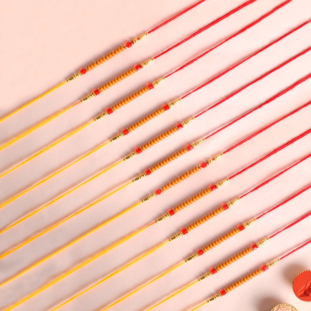 Assortment of 12 Rakhis, featuring different designs, threads, and embellishments for Raksha Bandhan. India’s Largest Pooja Accessories Brand - www.satvikworld.com