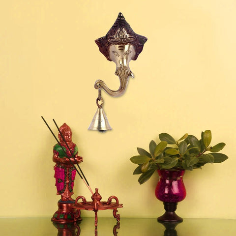 Brass decorative Ganesh wall hanging featuring Lord Ganesha with intricate detailing and a bell at the bottom, symbolizing blessings, prosperity, and the removal of obstacles. Ideal for home or temple décor. India’s Largest Pooja Accessories Brand – www.satvikworld.com
